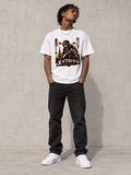 Model wearing Ape Street Apezilla Tee, front view showing the design, against a light concrete backdrop.