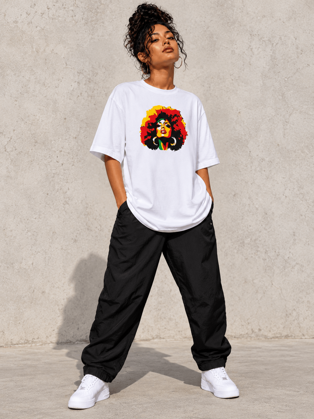 Model wearing Moda Originals Caribbean Soul Tee, front view showing the design, against a light concrete backdrop.