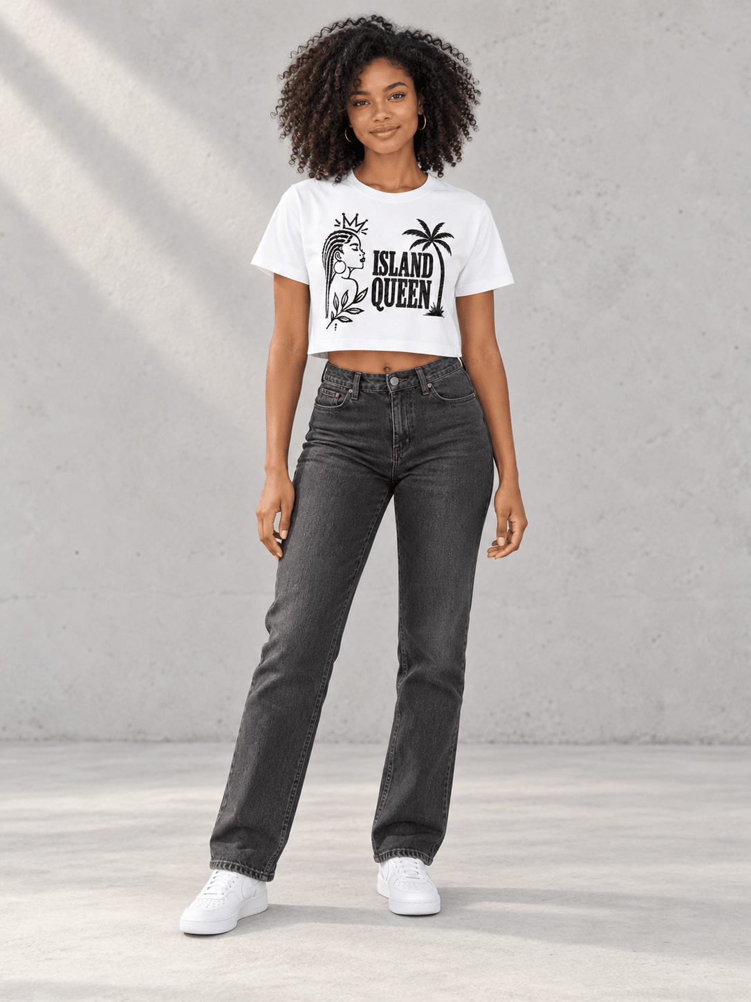 Model wearing Moda Originals Island Queen Crop Tee — White, front view showing the design, against a light concrete backdrop.