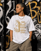 Women’s T-shirt featuring a gold “She Built Her Own Kingdom” empowerment graphic by Moda Originals.