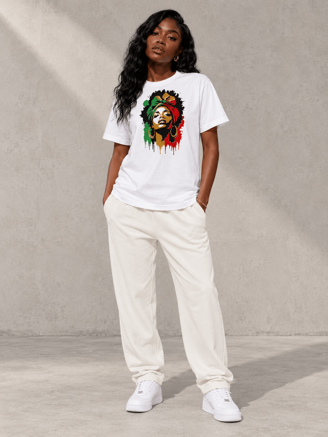Model wearing Moda Originals Roots & Rhythm Tee, front view showing the design, against a light concrete backdrop.