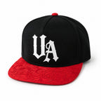 Urban Avenue black cap with white UA logo and red patterned flat peak, front view.