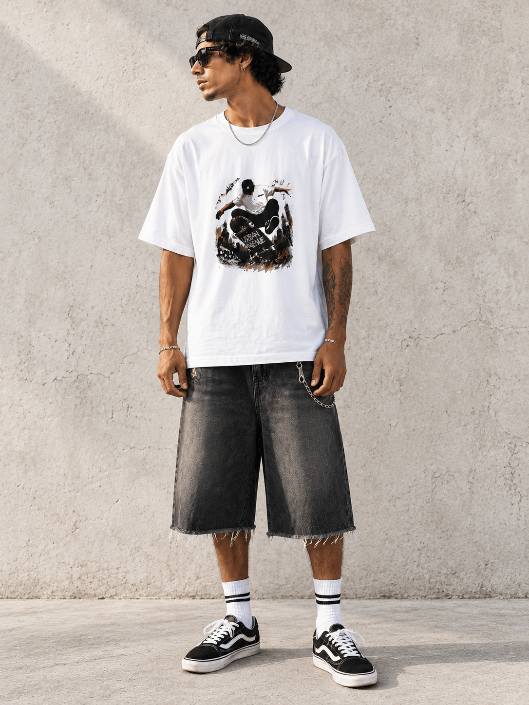 Model wearing Urban Avenue Board Control Tee, front view showing the design, against a light concrete backdrop.