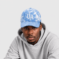 Model wearing Urban Avenue light blue and white baseball cap against a light grey catalogue background.