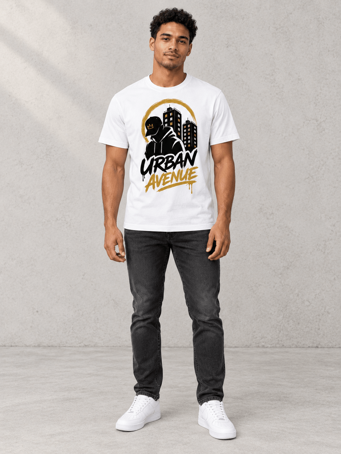 Model wearing Urban Avenue Streets Tee, front view showing the design, against a light concrete backdrop.