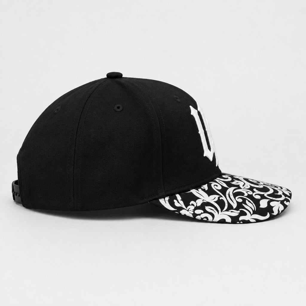 Urban Avenue UA baseball cap in black and white, side view.