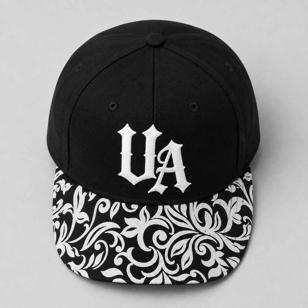 Urban Avenue UA baseball cap in black and white, top view.