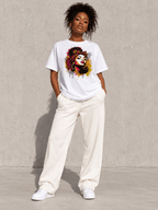 Model wearing Moda Originals Wild Spirit Tee, front view showing the design, against a light concrete backdrop.